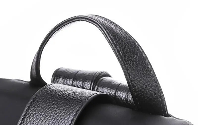 Women’s black nylon backpack with textured leather-like top handle