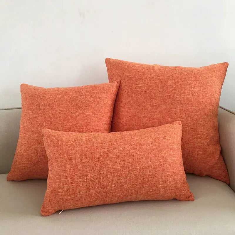 Sofa cushion covers set in orange textured fabric on a beige sofa (three cushions)