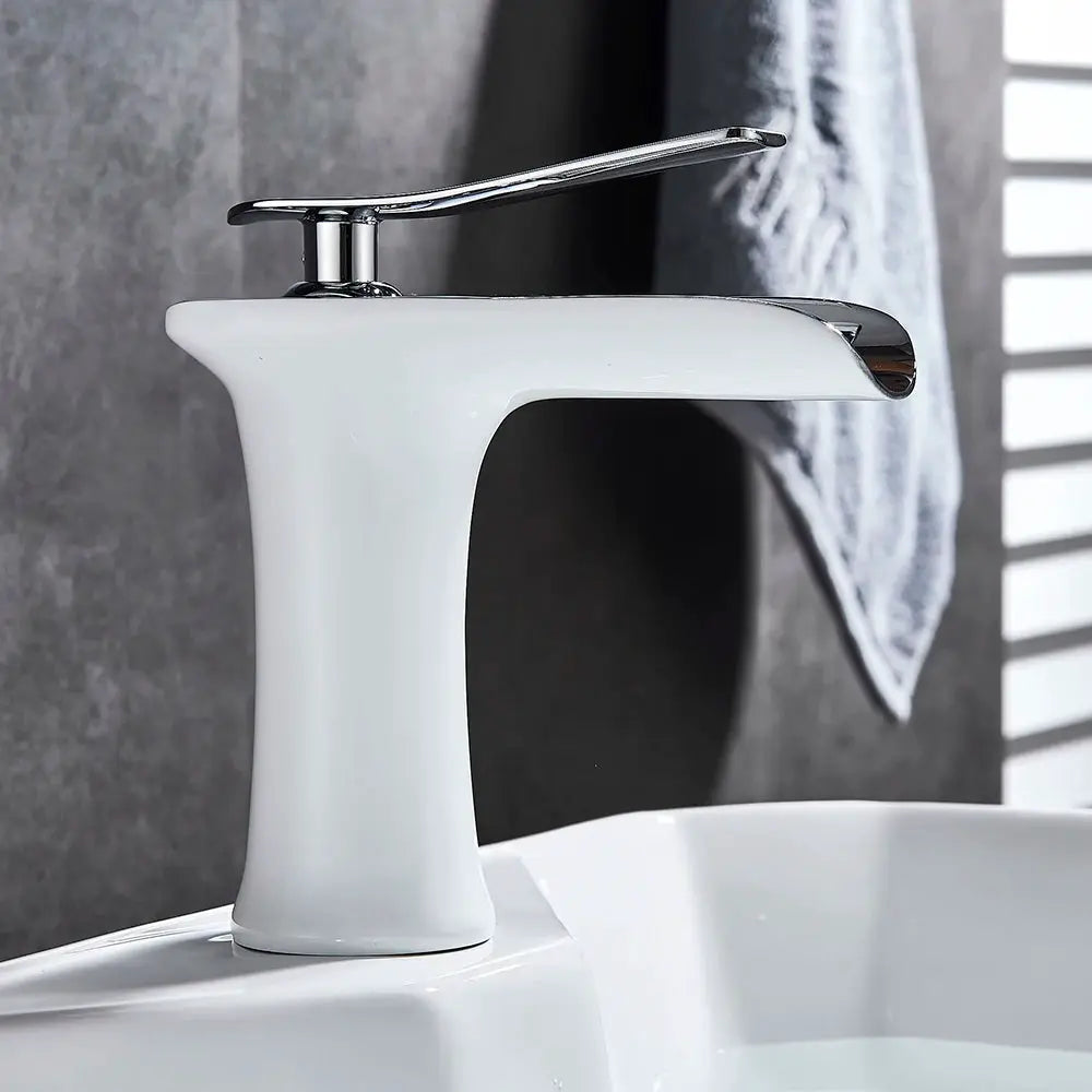 Simples Market bathroom basin faucet with white ceramic body and chrome waterfall single-handle lever.