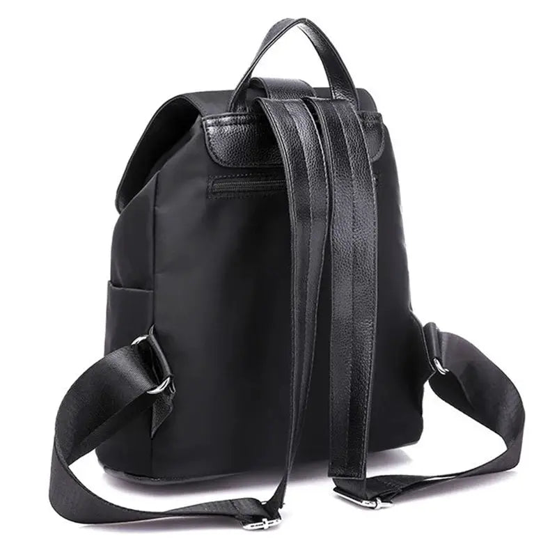 Women's black nylon backpack with top handle and adjustable straps, large-capacity casual travel bag.