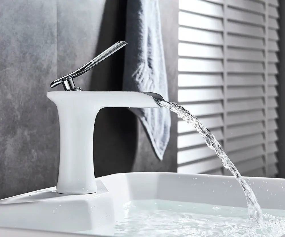 Basin faucet with white finish and single-handle chrome lever, waterfall flow, mounted on sink