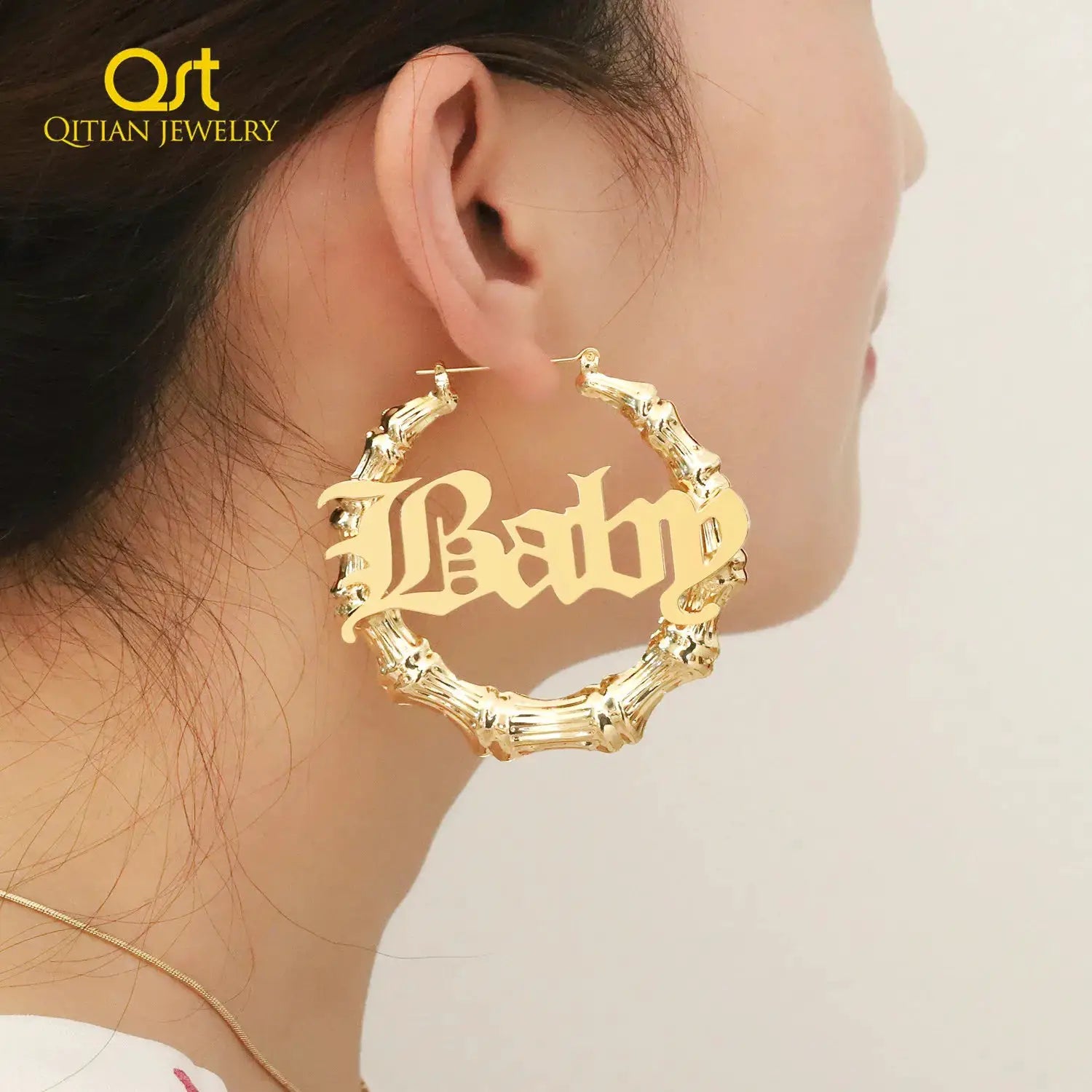 Gold bamboo hoop earring with Baby name inscription, single piece; Qitian Jewelry logo visible.