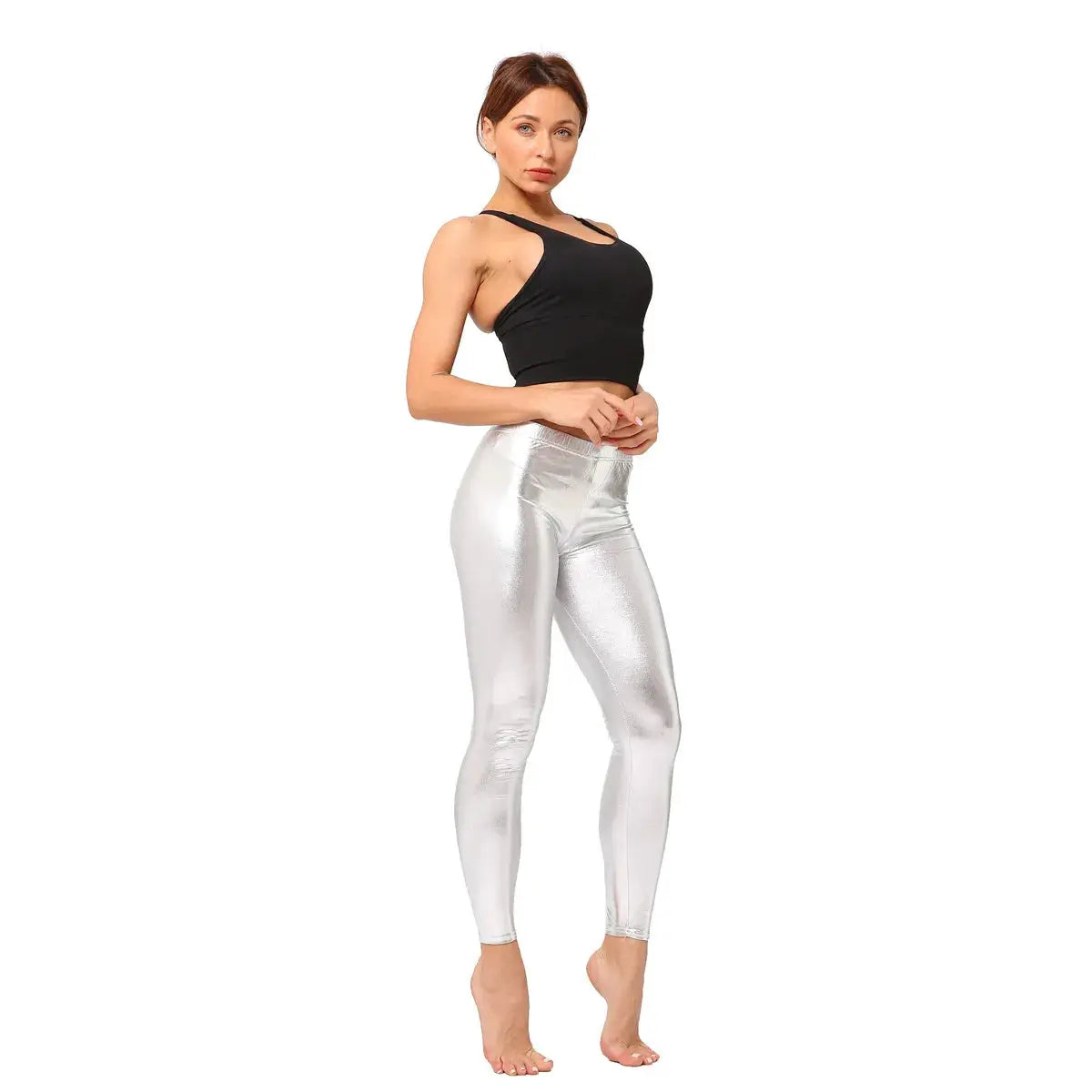 Ladies silver metallic laser-leather leggings worn by a model in a black crop top