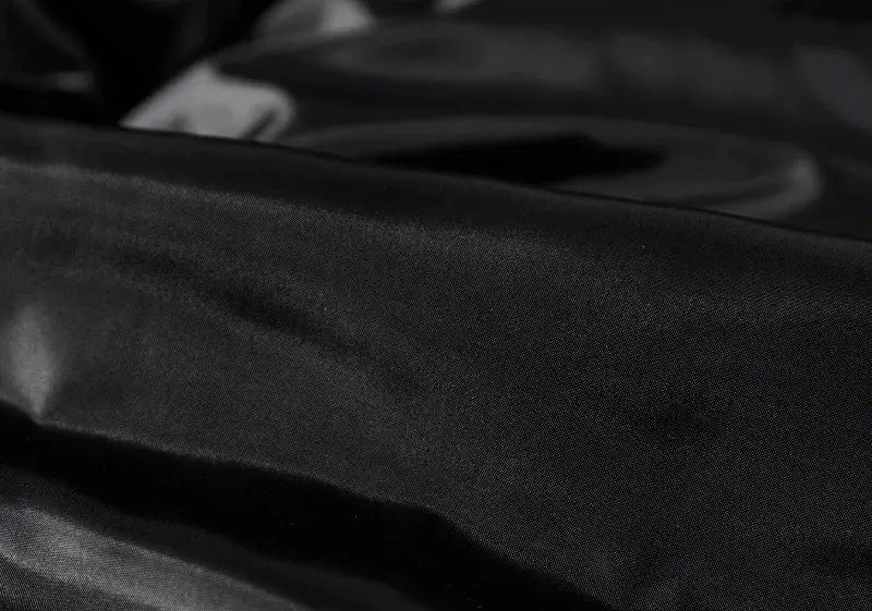 Men's sleeveless vest fabric close-up in black satin-like material