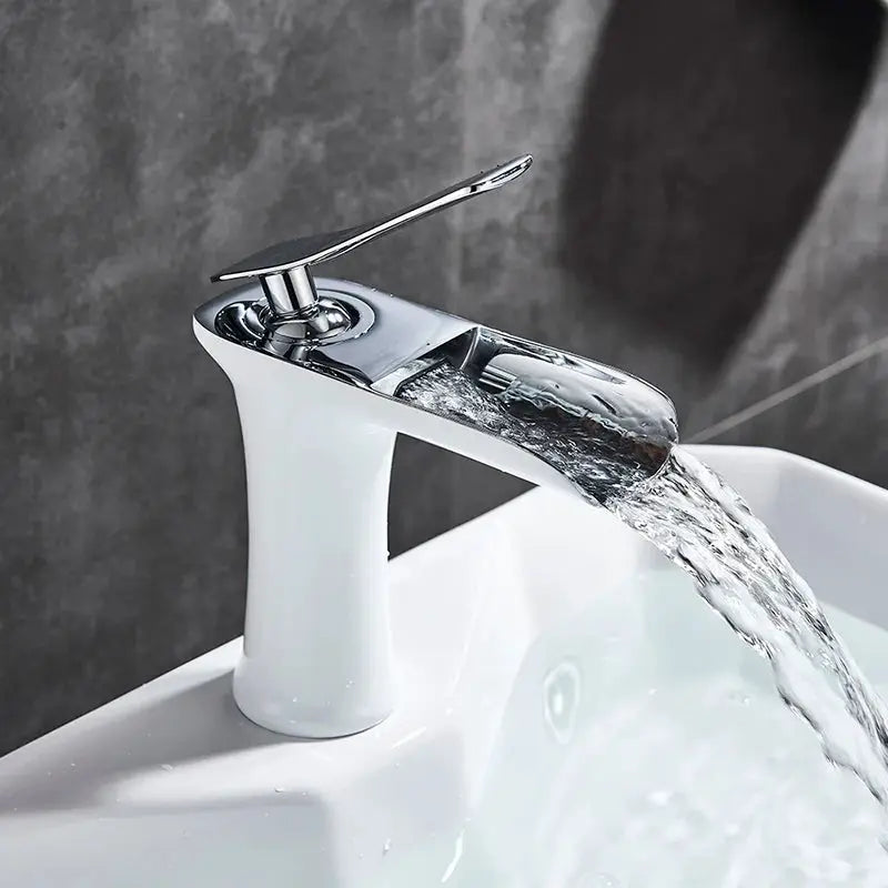 Basin faucet with a single-handle chrome waterfall spout, designed for modern bathroom sinks with a polished finish.