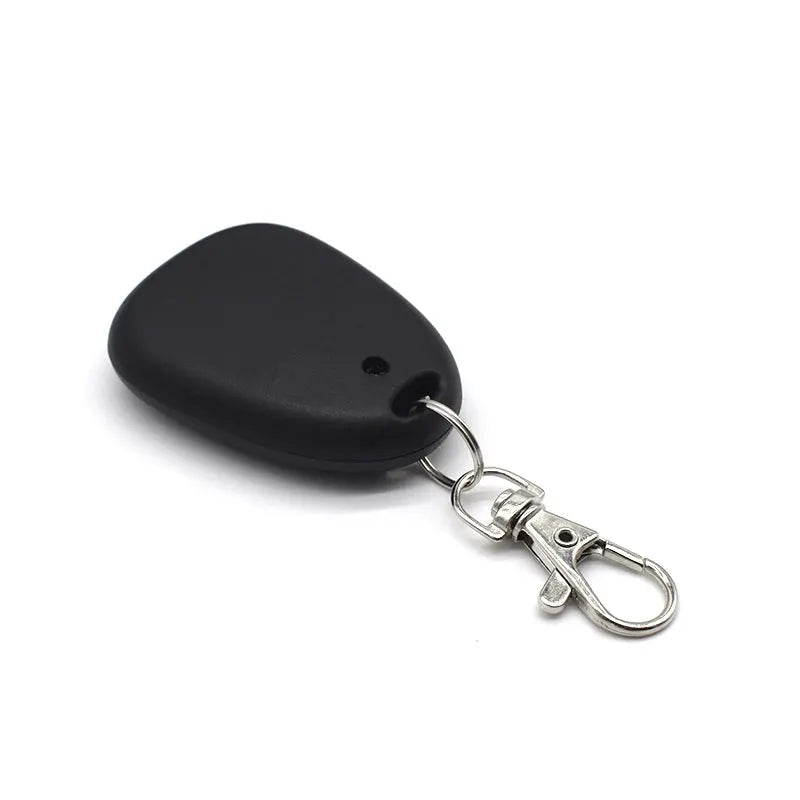Garage door remote control key fob, black plastic, 433MHz fixed-code transmitter with metal keyring.