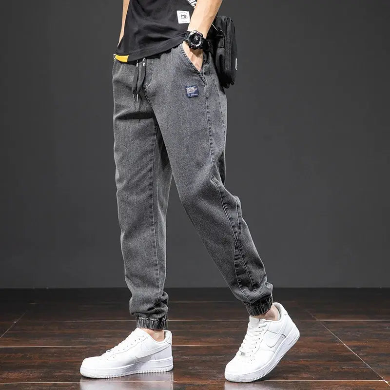 Men's dark grey denim cargo jogger pants with elastic cuffs and drawstring waist