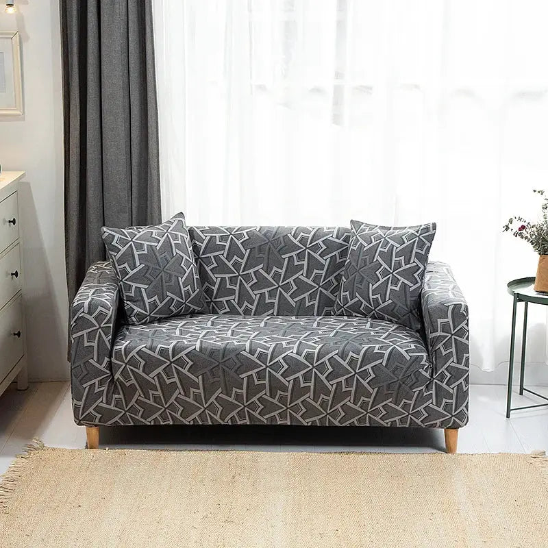 Sofa slipcover in gray stretch fabric with a geometric white pattern for a two-seat couch