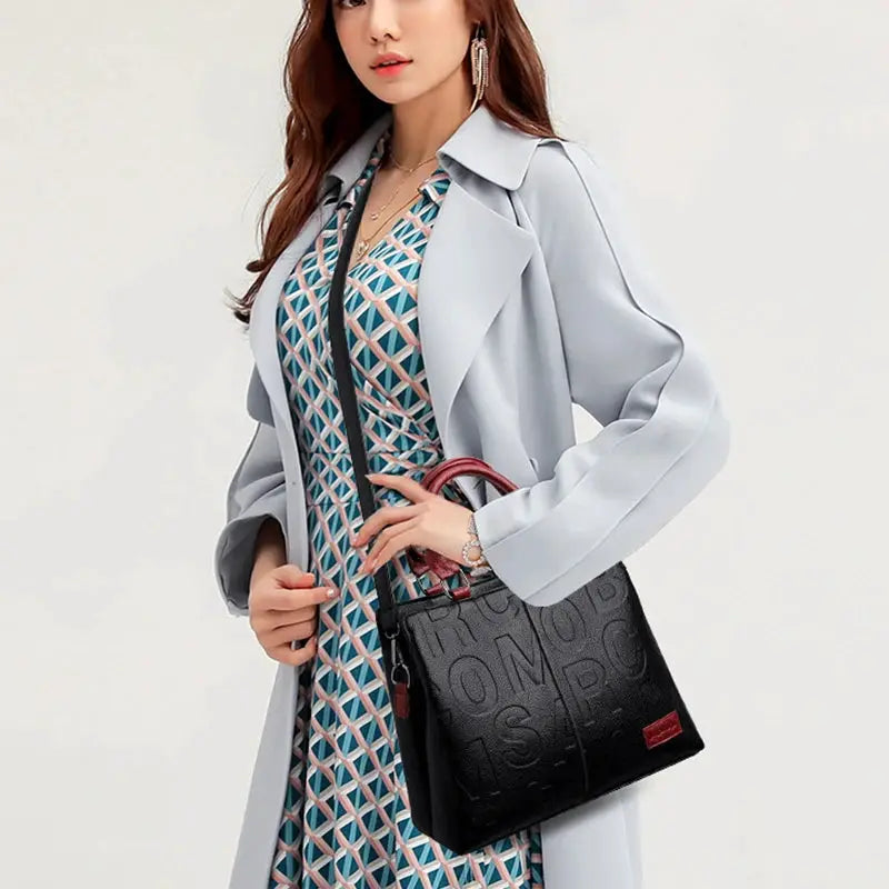 PU leather crossbody bag for women, black with embossed lettering and red accent handle, Simples Market.