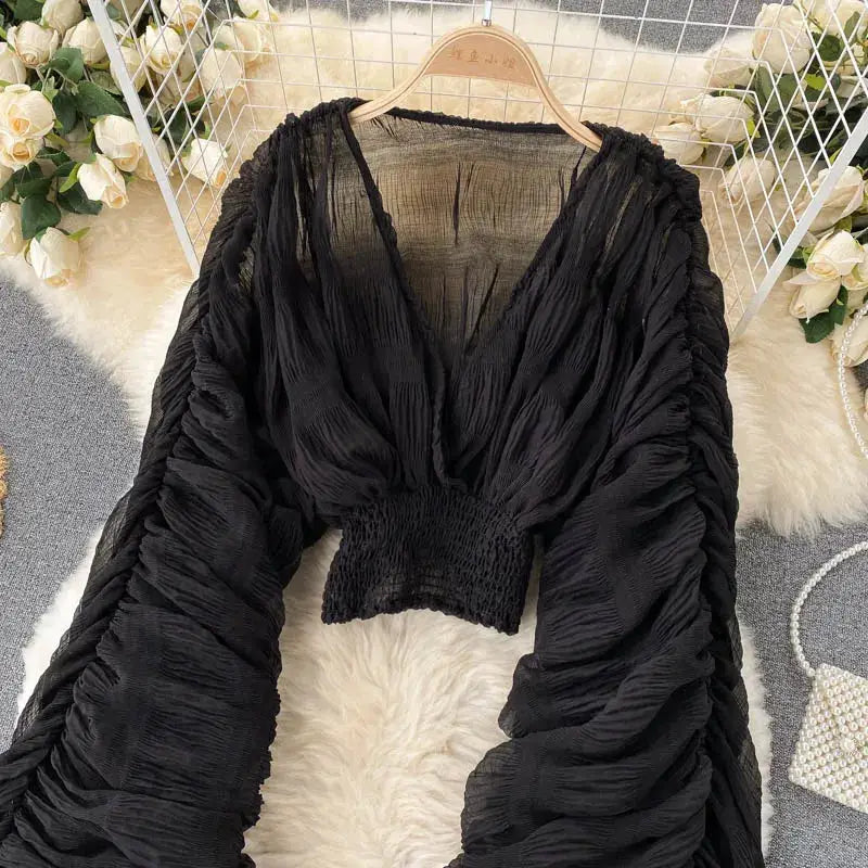 Black chiffon draped blouse with V-neck and puff long sleeves, cropped smocked hem