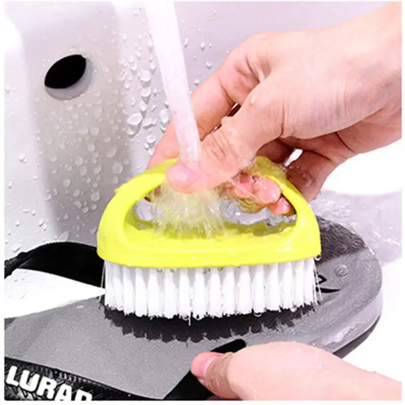 Egg-shaped yellow cleaning brush with white bristles for shoes and household surfaces