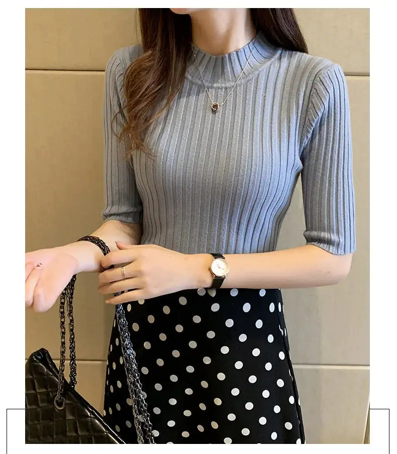 Grey ribbed knit short-sleeve blouse with crew neck, paired with a black polka-dot skirt (2-piece outfit)