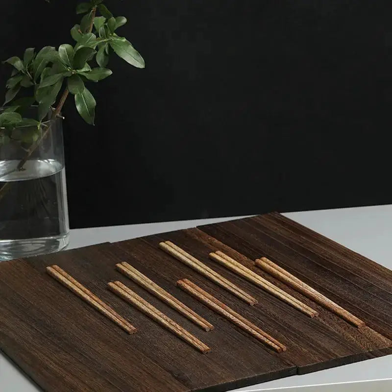 Wooden chopsticks, natural rosewood, 10 pairs on a dark wood board