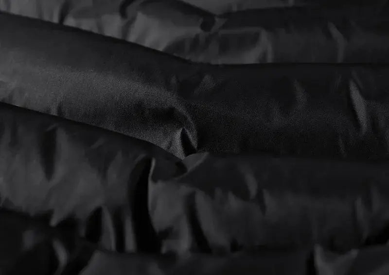 Men's sleeveless vest fabric close-up in black, smooth material