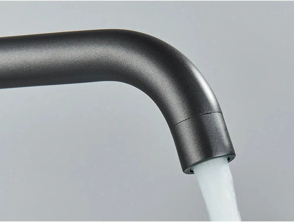 Basin faucet by Simples Market, black brushed finish with curved spout and running water