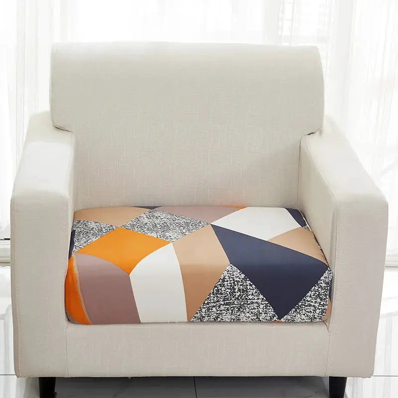 Simples Market geometric sofa cover for armchair; beige elastic slipcover with multicolor geometric seat pattern.