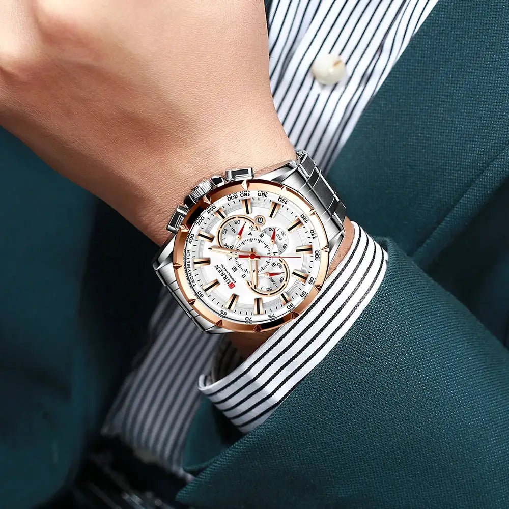 Curren men's stainless steel chronograph watch on wrist with white dial, rose-gold bezel, silver band