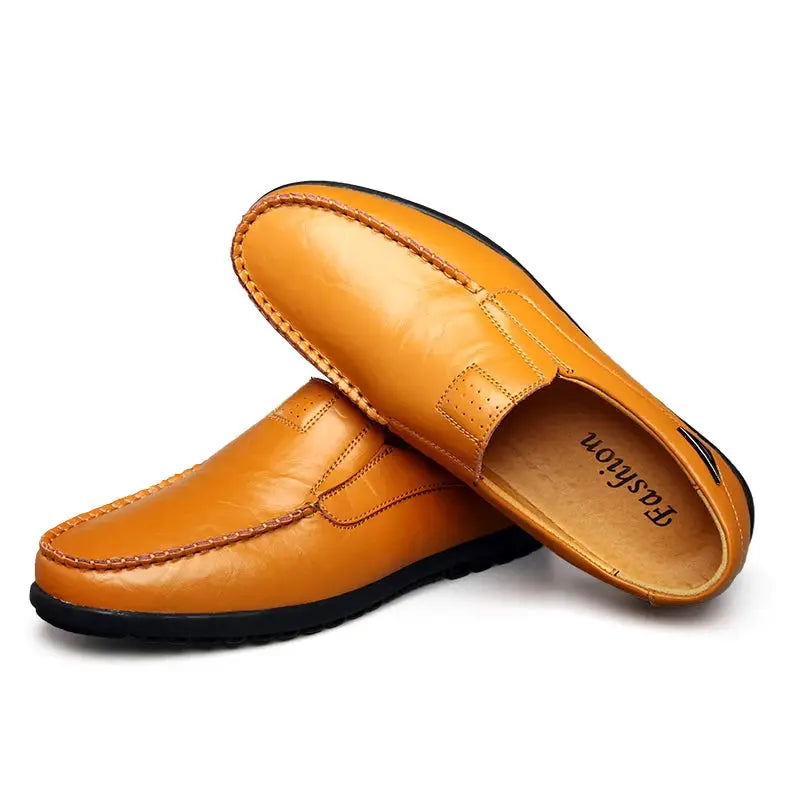 Pair of tan genuine leather men's loafers, slip-on moccasins with black outsole.