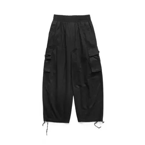Men's black oversized cargo pants with multiple pockets, baggy wide legs, and drawstring ankle hems.