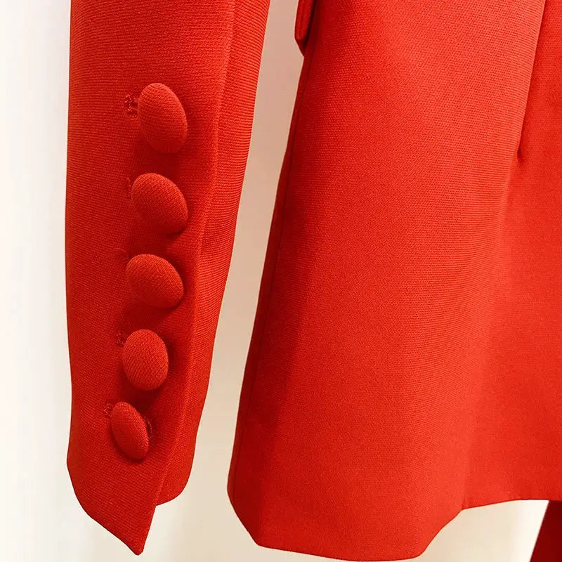 Red women's blazer with a row of fabric-covered sleeve buttons.