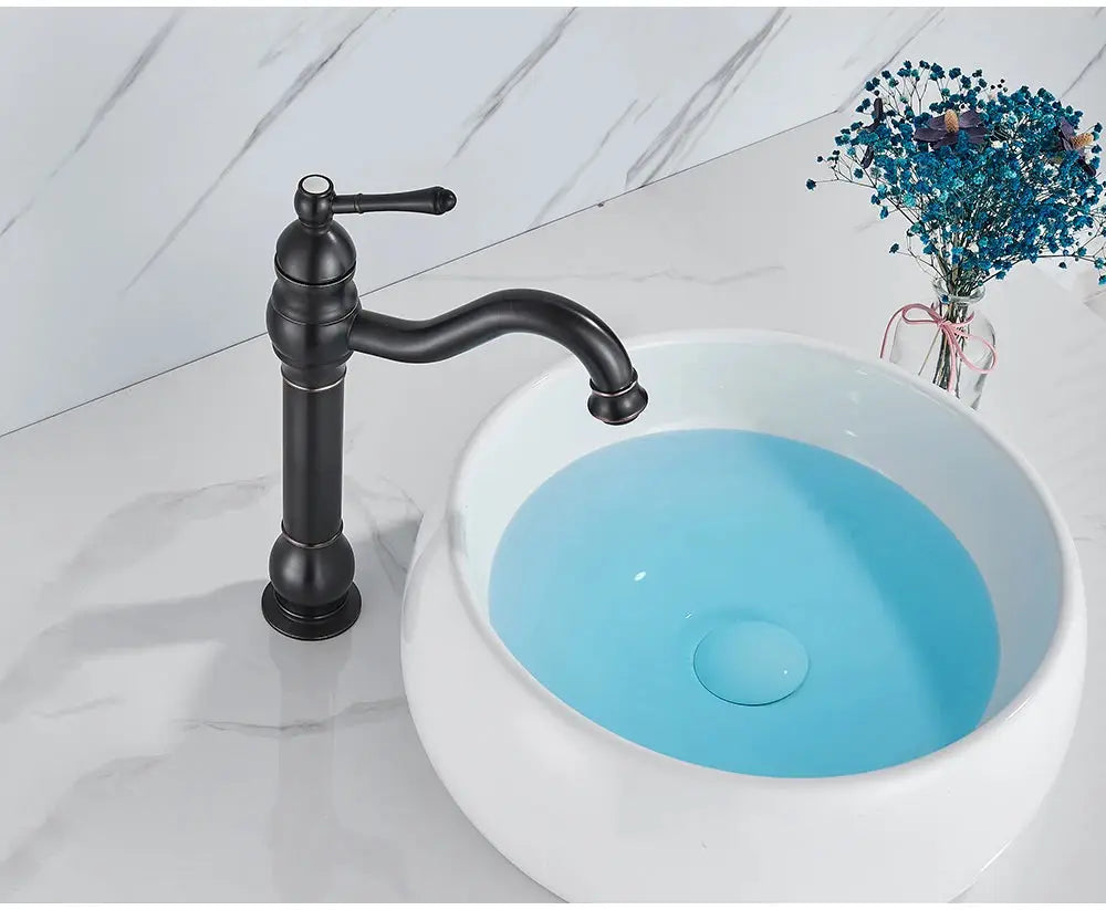 Basin vessel faucet in antique brass, deck-mounted one-hole hot/cold mixer.