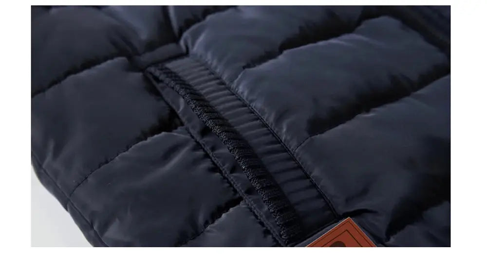 Men's navy padded sleeveless vest with quilted panels and black trim