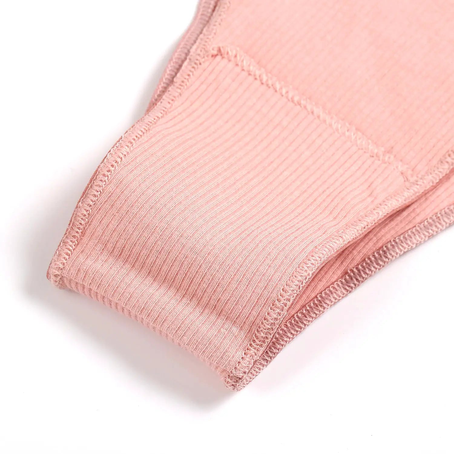 Pink cotton ribbed women's panties, low-waist briefs, close-up of fabric and stitching