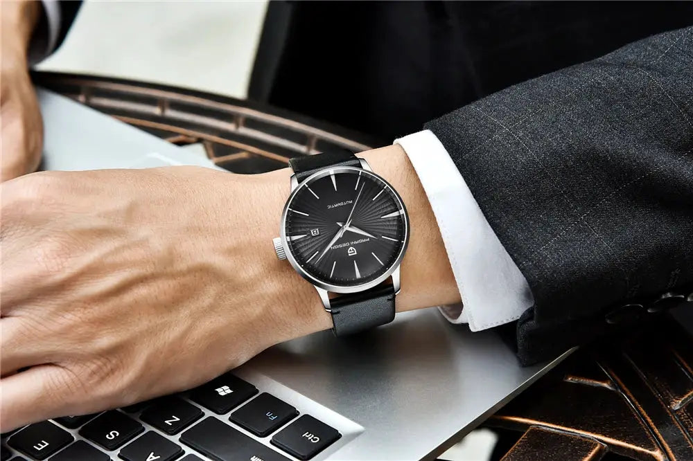 PAGANI DESIGN men's watch with black dial, silver case, and black leather strap on a suited wrist