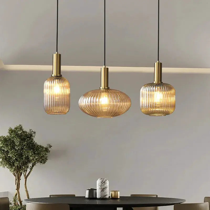 Glass pendant lights, trio of ribbed amber pendants with brass tops for dining room decor