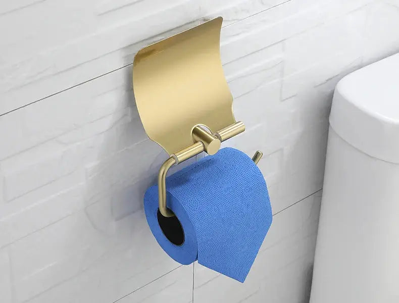Brushed gold wall-mounted toilet paper holder with curved bar and blue toilet paper roll