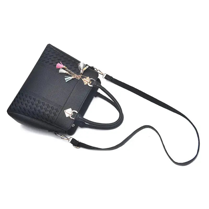 Simples Market black PU leather handbag with tassel charms, top-handle and crossbody strap