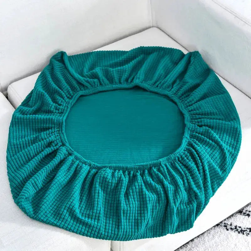 Sofa seat cushion cover in teal stretch fabric with elastic edge, removable and washable.