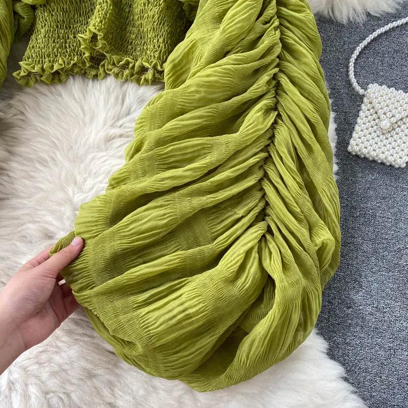Draped chiffon blouse in green with ruched detailing and long puff sleeves
