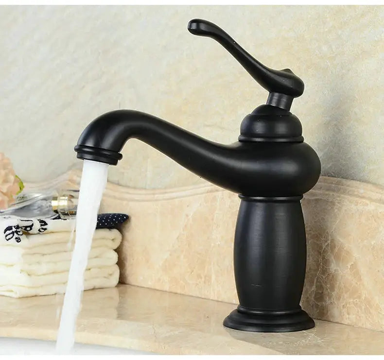 Antique bronze finish bathroom faucet with single-handle lever for brass basin on marble countertop