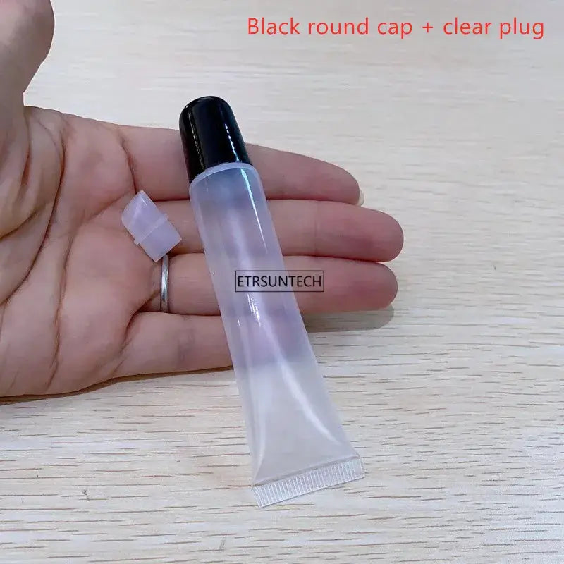 Lip gloss container, clear plastic squeeze tube with black cap, empty, ETRSUNTECH brand, held in hand