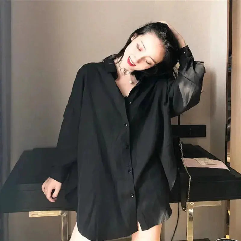 Black oversized women's button-up shirt, long sleeves, loose tunic blouse