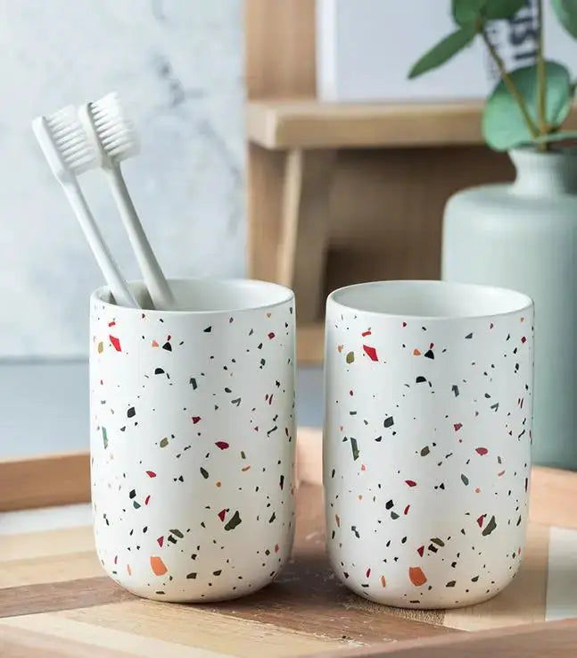 Terrazzo ceramic bathroom cups (set of 2) with toothbrushes in one; white with colorful speckled pattern