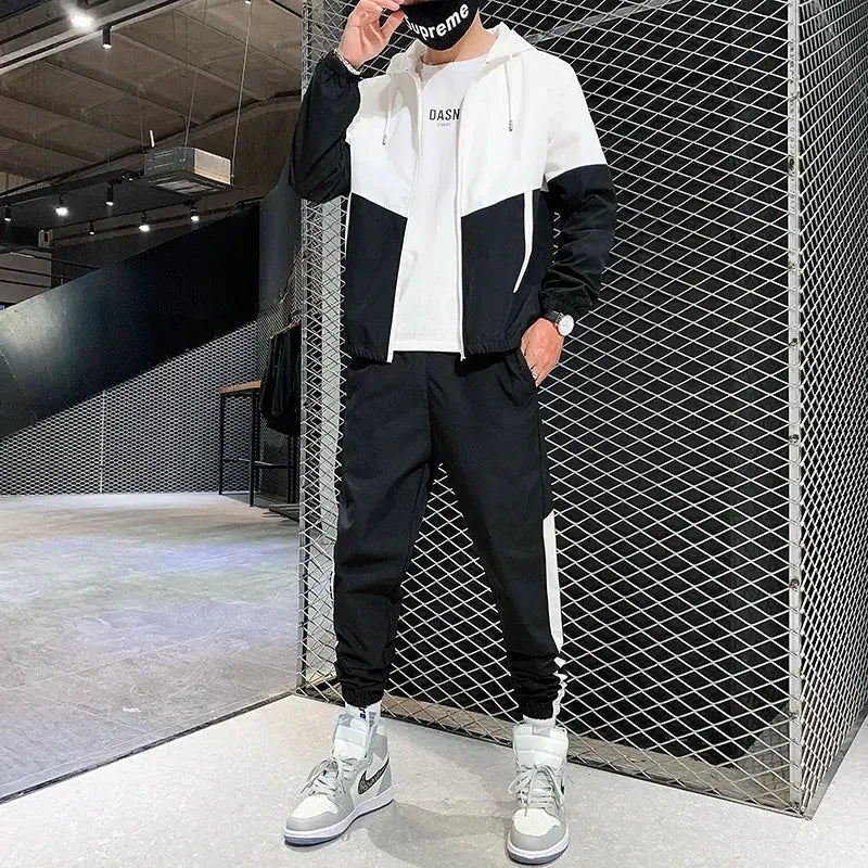 Men's black-and-white two-piece tracksuit set with hooded jacket and jogger pants by Simples Market