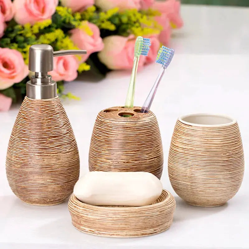 Bathroom ceramic 4-piece set with beige ribbed dispenser, toothbrush holder, rinse cup, and soap dish.