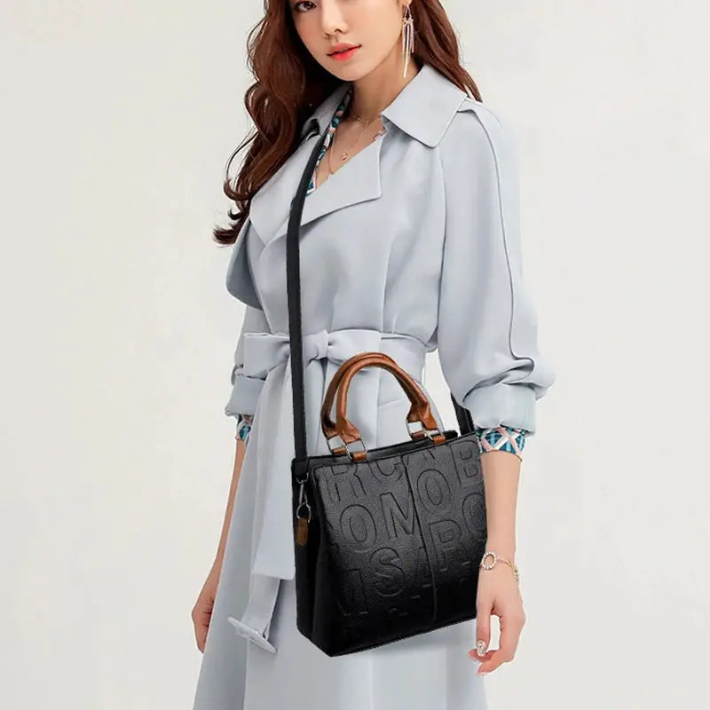 PU leather crossbody bag for women, black with brown top handles, long strap, embossed pattern
