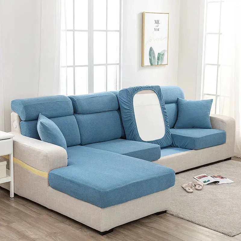 Blue elastic sofa cover set for an L-shaped sofa with matching cushions