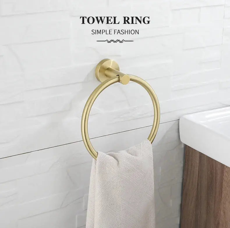 Towel ring in brushed gold finish, wall-mounted bathroom accessory with white towel.