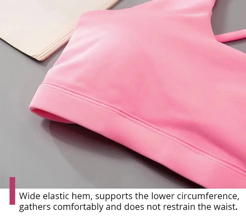 Pink crop-top sports bra for women with wide elastic hem.
