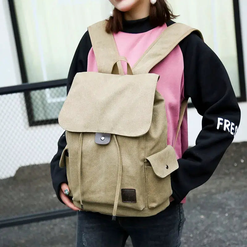 Canvas backpack beige with flap closure and front pocket