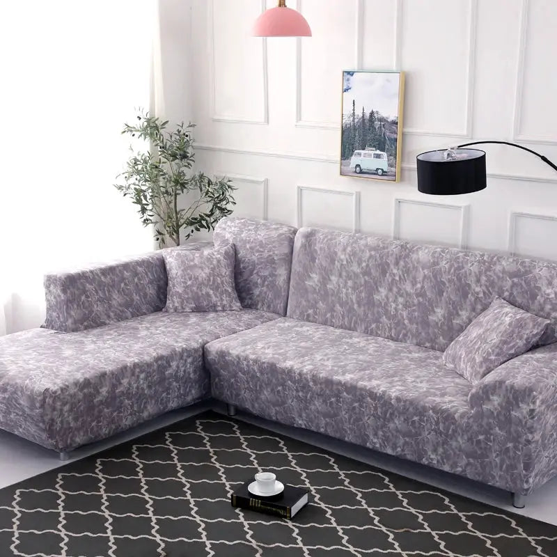 Sofa slipcover for L-shaped corner couch; printed lavender-gray stretch fabric.