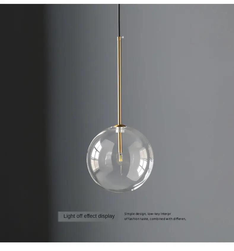 Modern LED pendant lamp with clear glass ball and gold suspension rod for bedroom or living room
