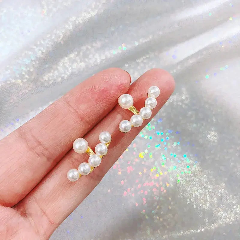 Imitation pearl arc earrings in a gold-tone setting, pair