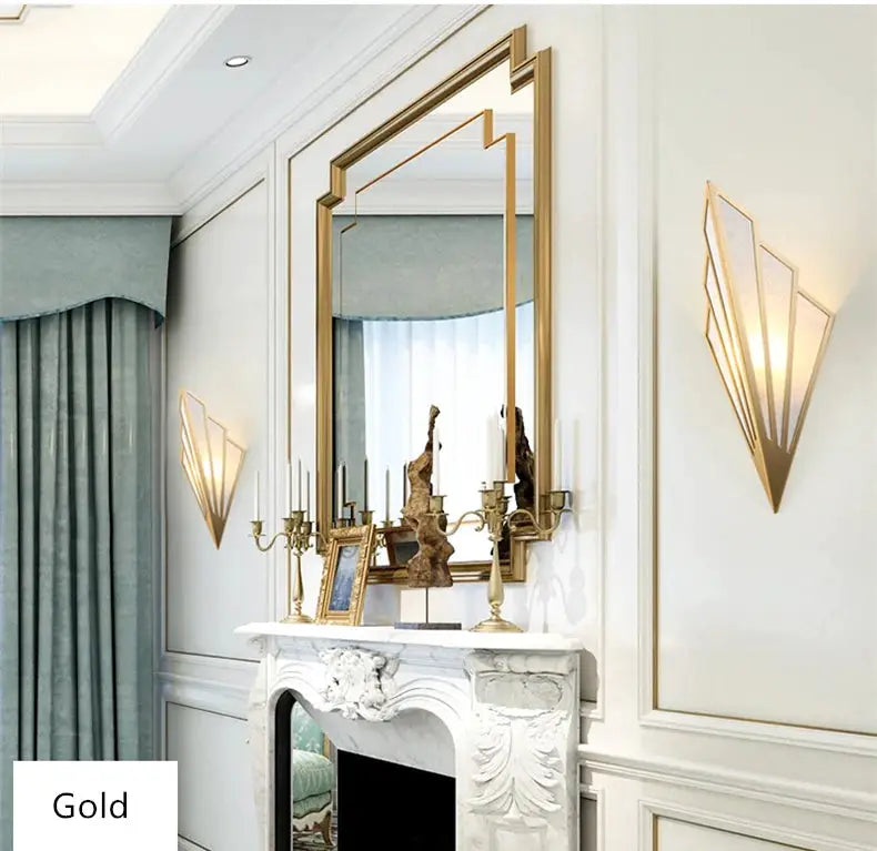 Two gold Nordic LED iron wall lamps flanking a large mirror above a white marble fireplace