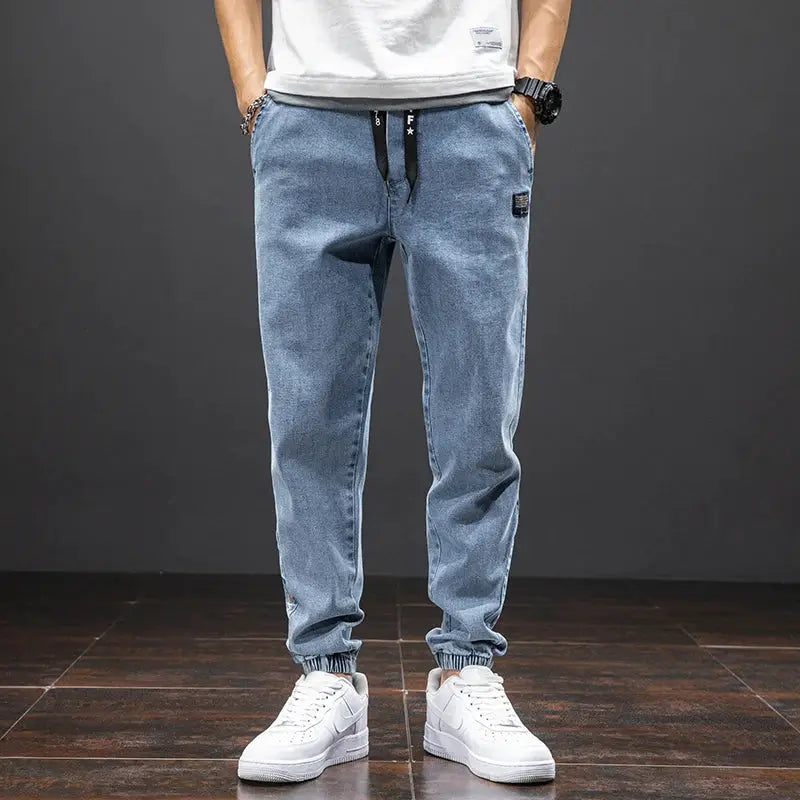 Denim cargo jogger jeans in blue with drawstring waist and elastic cuffs