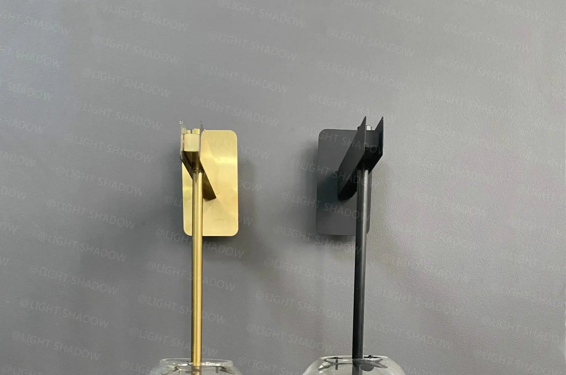 Modern glass wall light sconces in brass gold and matte black finishes; pair of decorative bedside lamps.